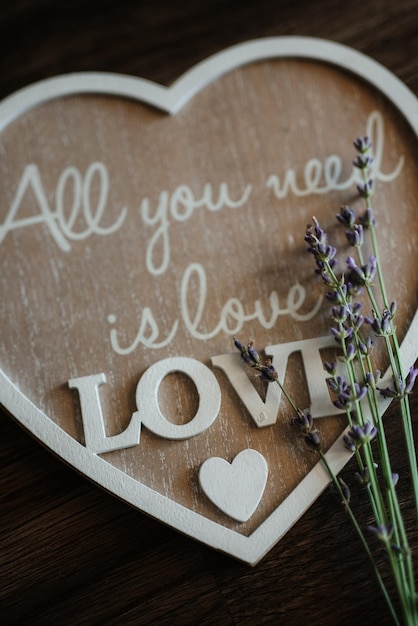 heart shaped woord with quotes and flower on top
