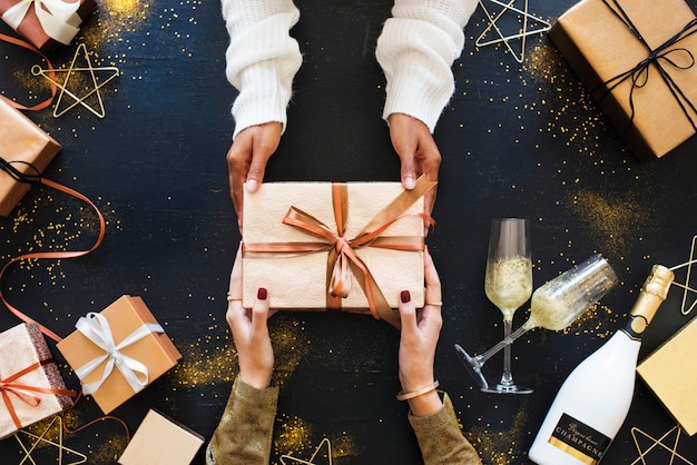 two people handing out gift