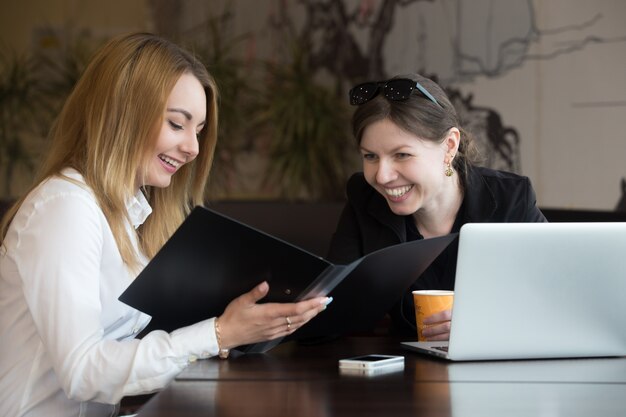 two women talking happily